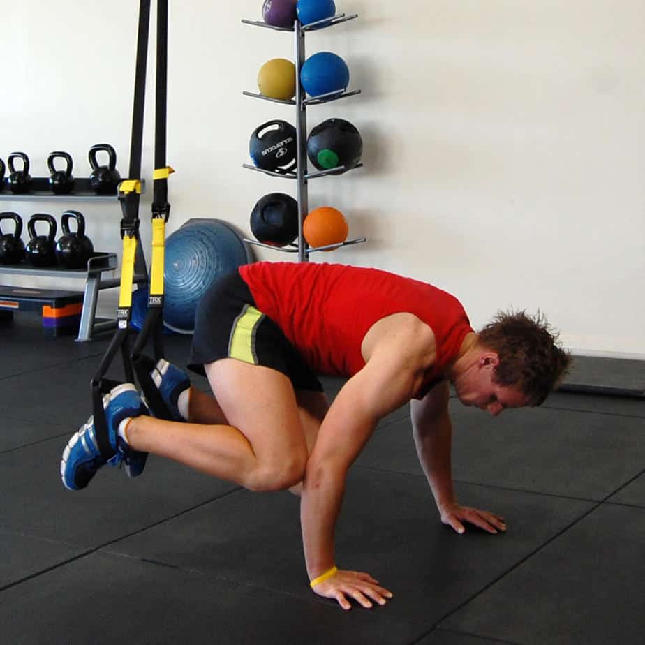 Man performing the TRX atomic push up