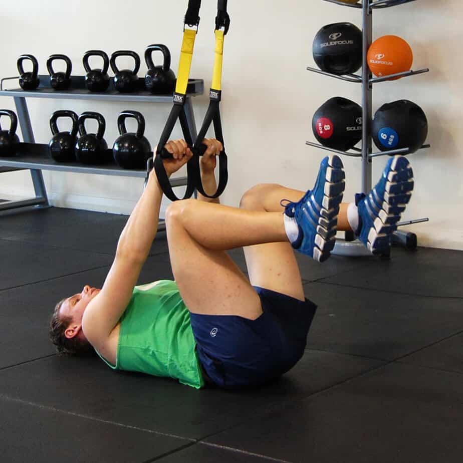 Man performing the TRX bent leg raise