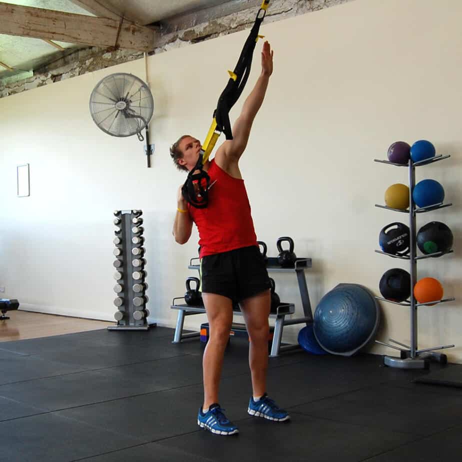 Man performing a TRX single arm reach