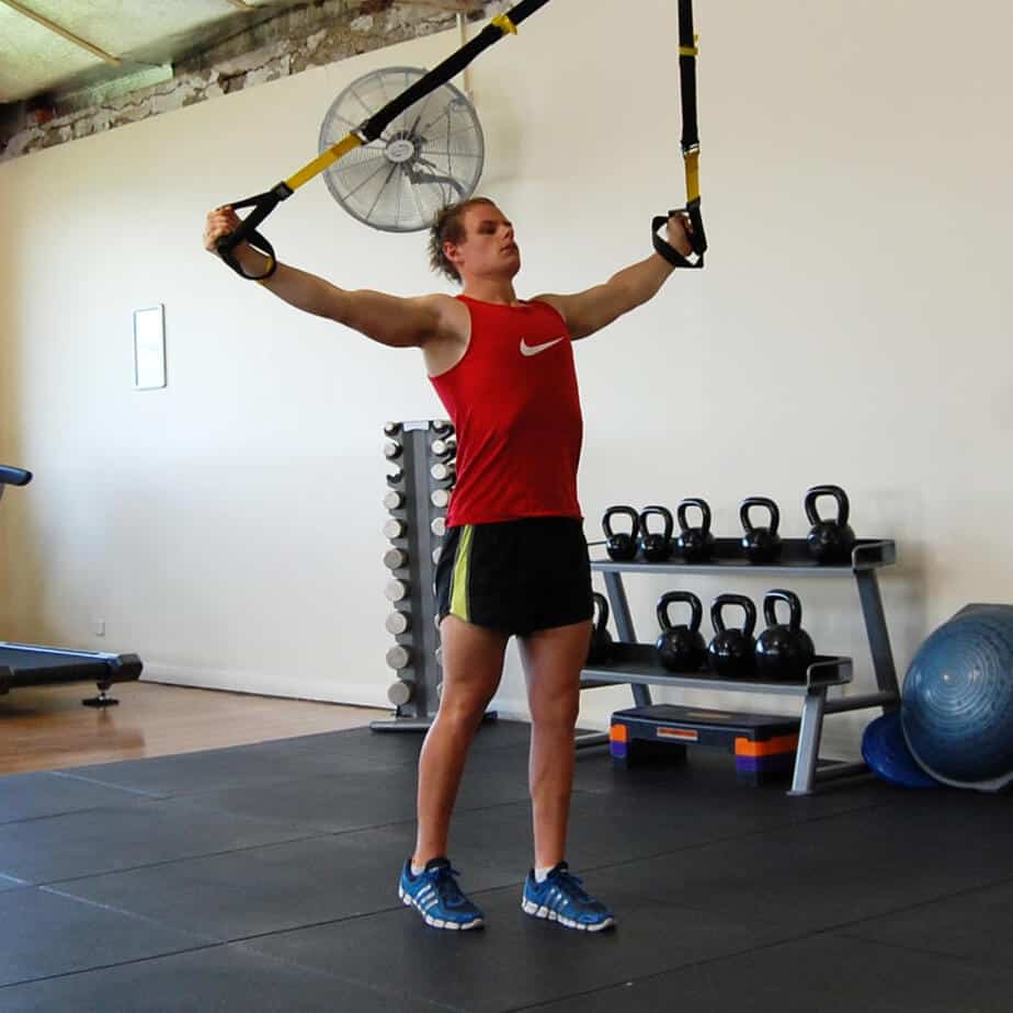 Man performing the TRX Y deltoid fly