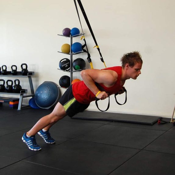 Man performing a TRX Front Squat Jump