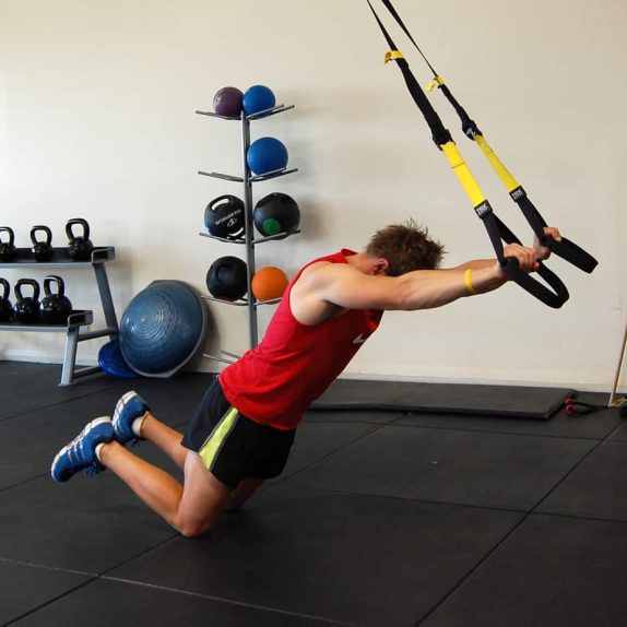 Man performing a TRX Kneeling Rollout