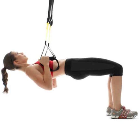 Woman performing TRX Table Rows